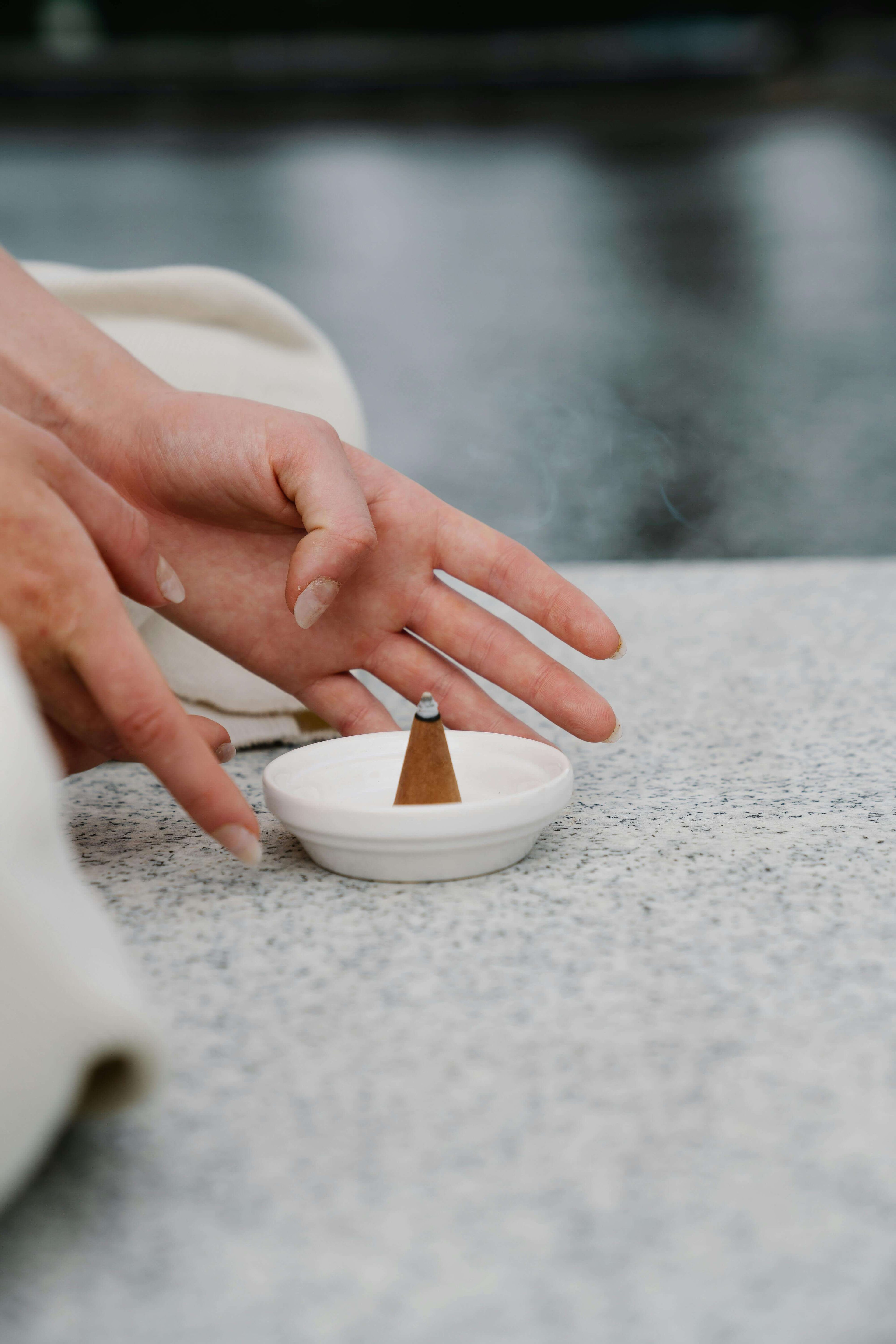 Person burning an incense cone