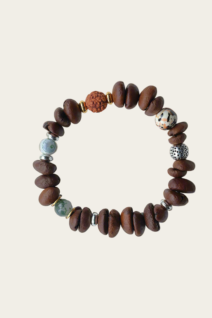Beaded bracelet with brown stones and colorful beads on a beige background